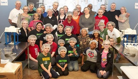 Sportsman's Guide staff gathered together while volunteering at Feed my Starving Children